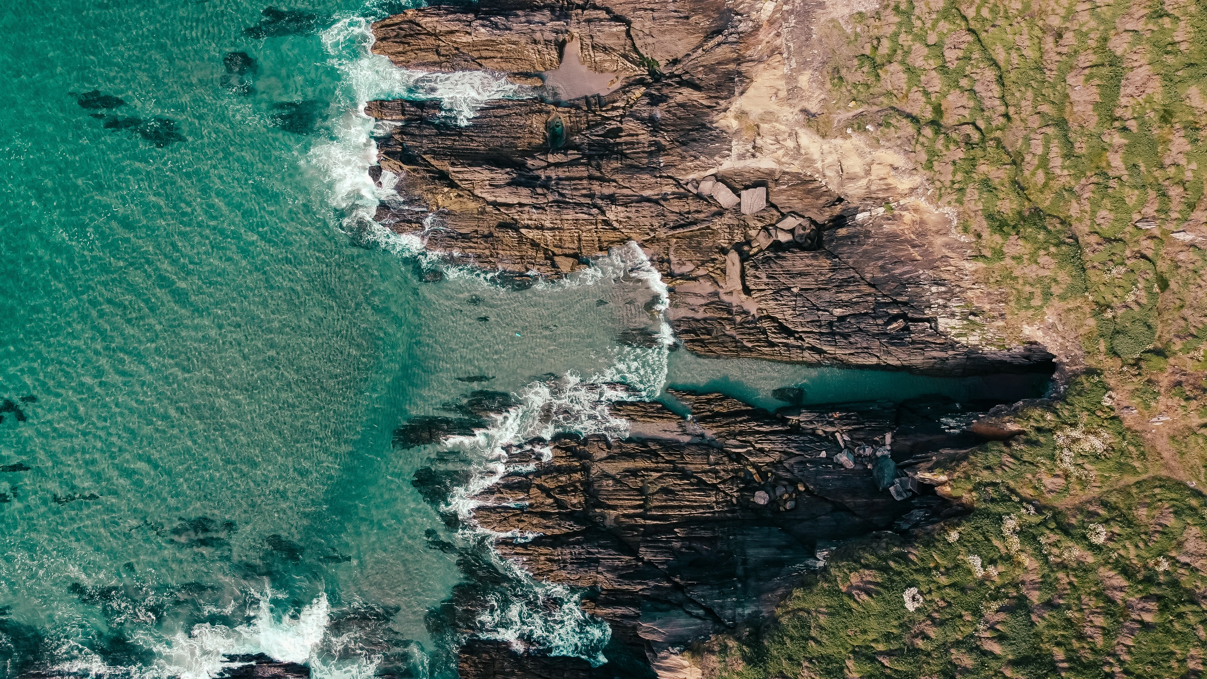 Rocky coastal cliffs along a shoreline.